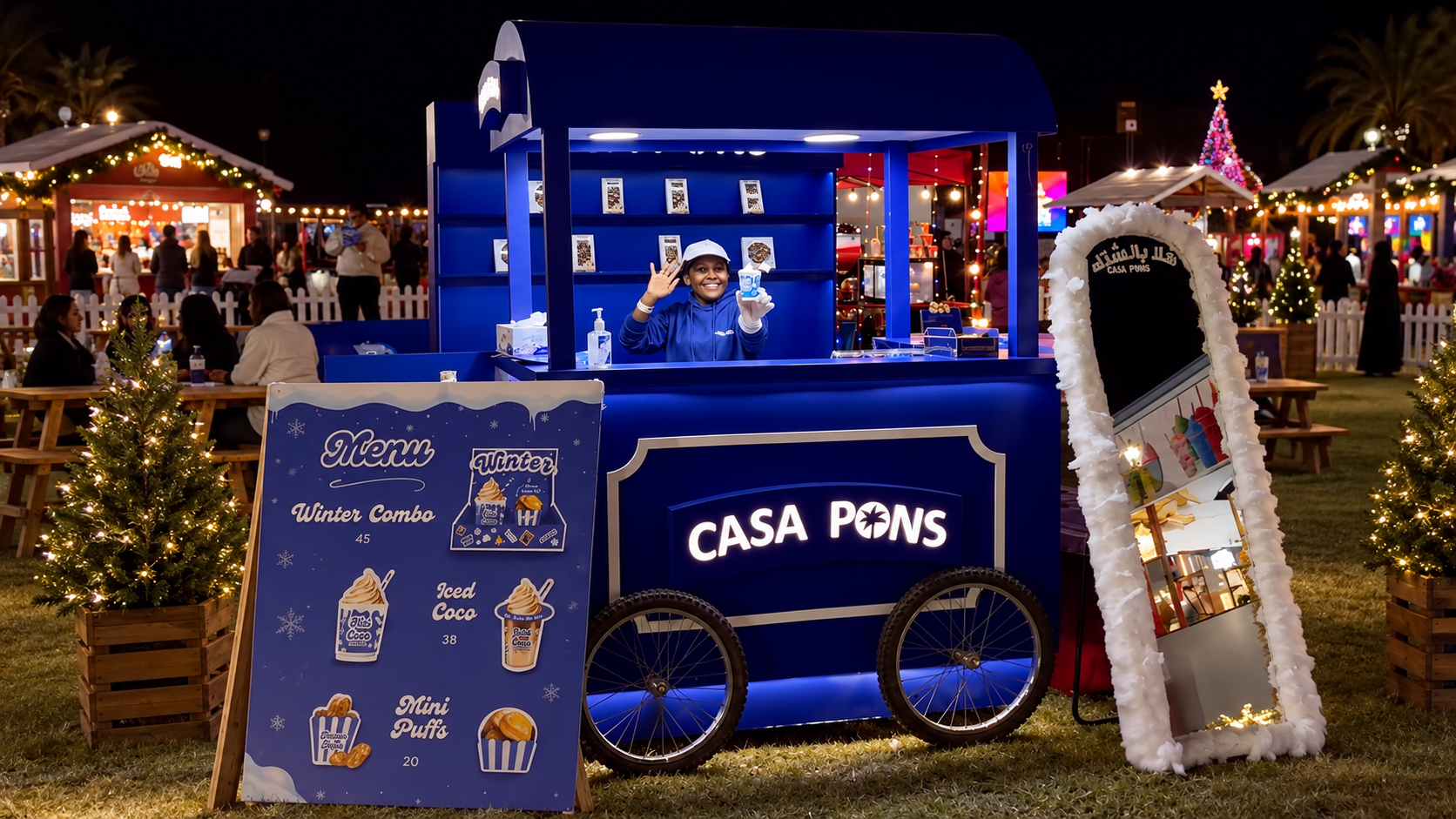 Casa Pons blue hot chocolate cart with menu board and branded mirror at a festive outdoor event